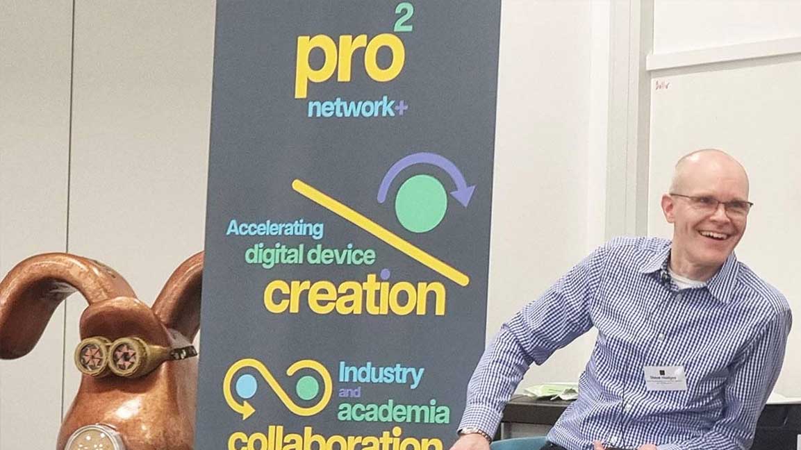 launch A photo of Steve Hodges smiling and looking to the right, with a white wall in the background, a large banner with the pro2 logo to his left, and a statue of Grommit.