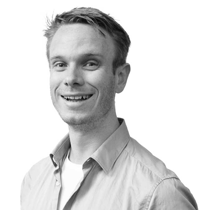 ChrisSnider A black and white photo of Chris Snider, smiling and facing the camera.