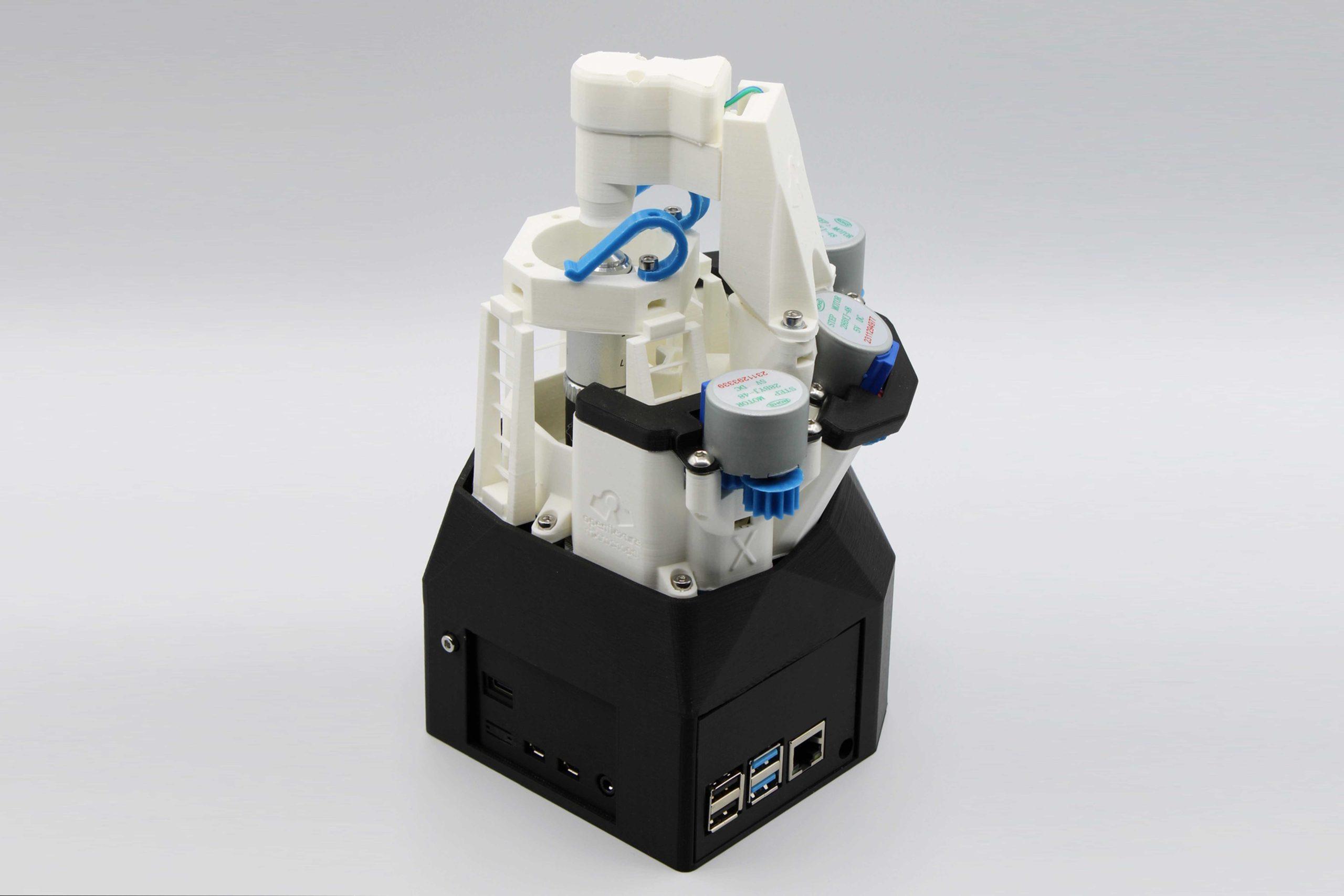 OpenFlexure_04 Photo of a 3D printed OpenFlexure microscope against a gray background.
