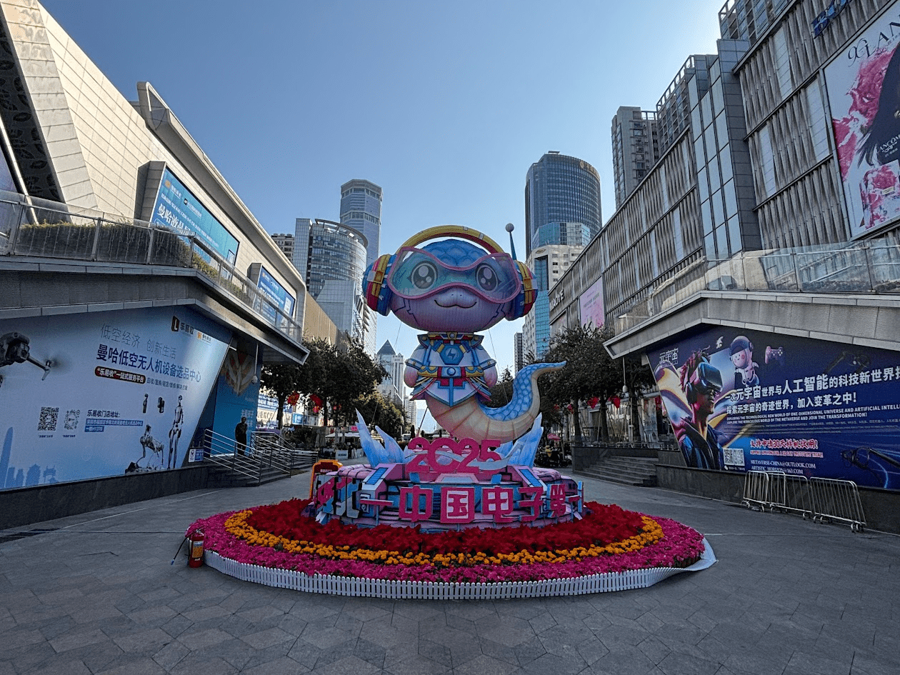 new year display A large lunar new year decoration in the form of a cartoon snake wearing goggles is surrounded by flowers in the Shenzhen city centre.