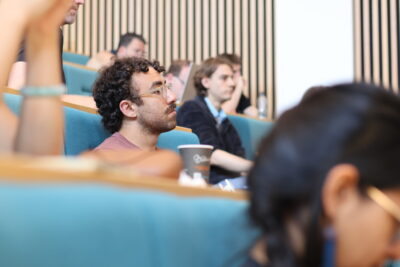 Delegates sit in a crowded lecture theatre at Lancaster University.